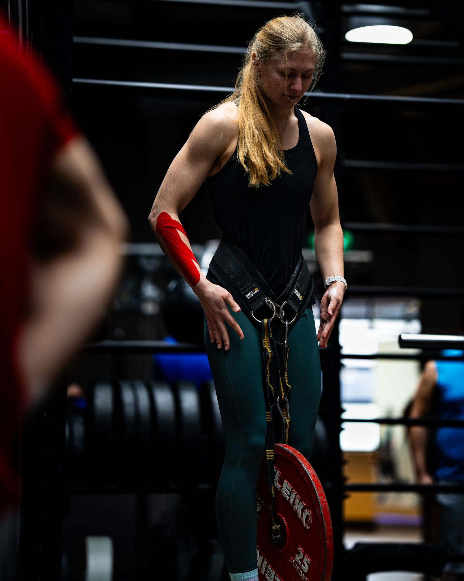 Athlete handling weighted plates during a strength training workout.