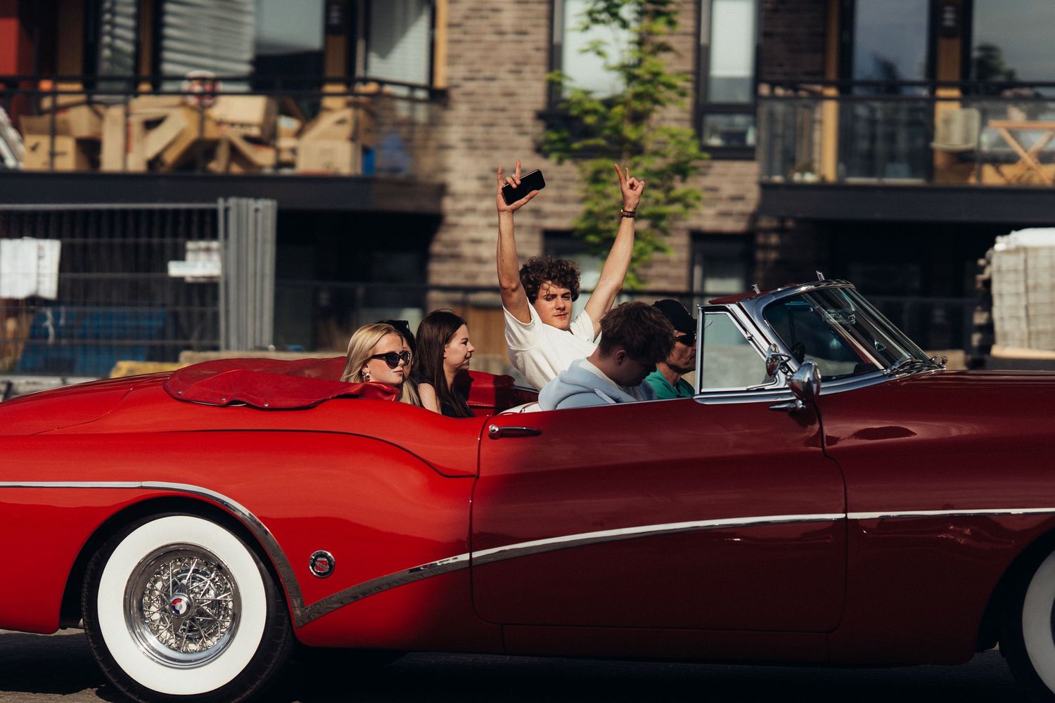 Classic red convertible cars lined up showing elegant vintage styling and chrome accents.