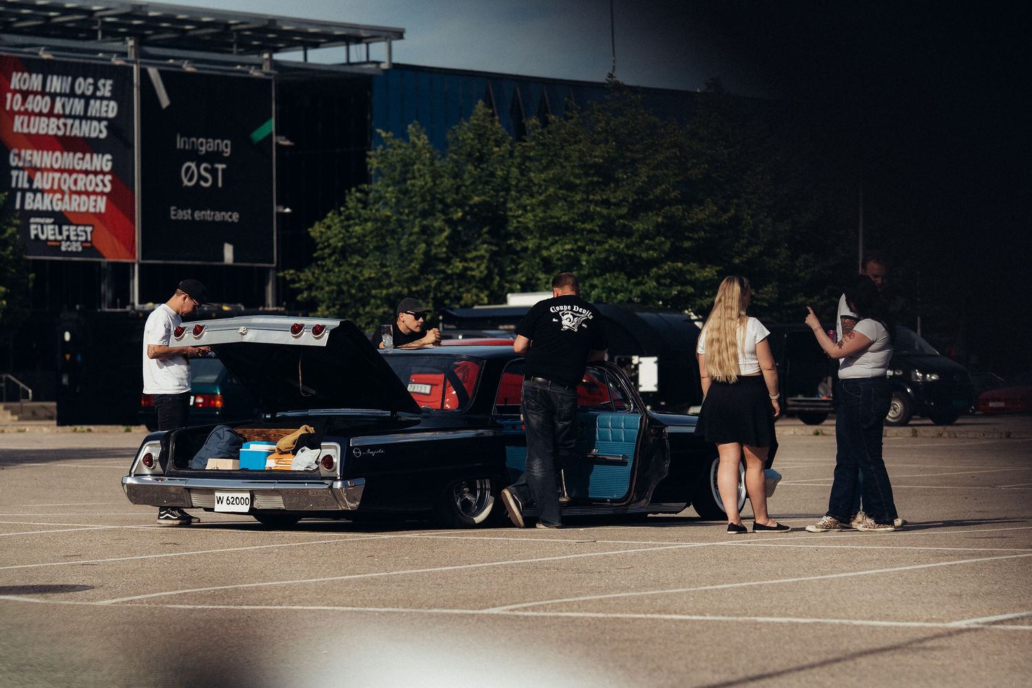 Vintage cars displayed at outdoor automotive gathering.