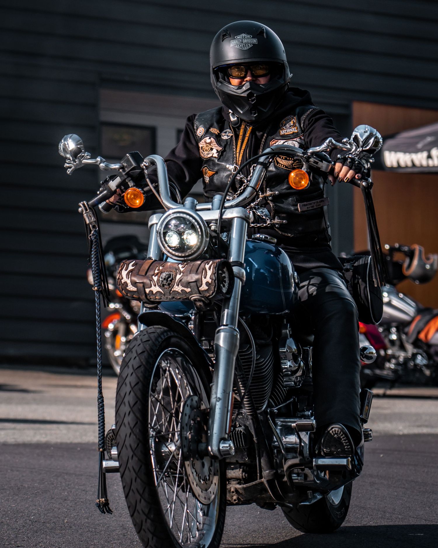 Black motorcycles parked in front of dealership showcasing classic Harley-Davidson styling.