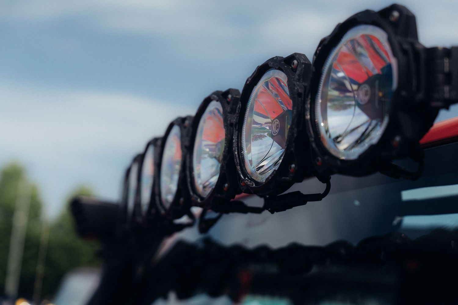 Row of black off-road LED light bars mounted on vehicle roof rack.
