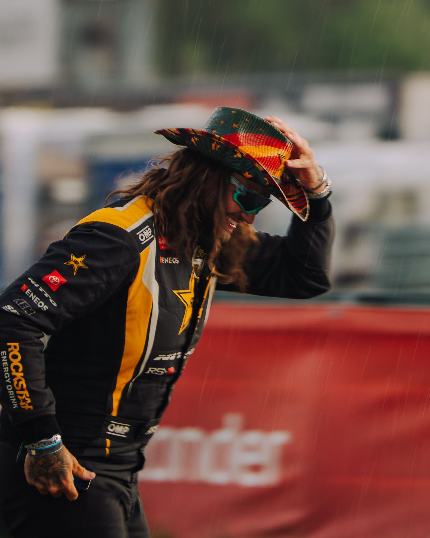 Formula 1 racing driver celebrates victory with a fist pump while wearing Red Bull Racing team gear.