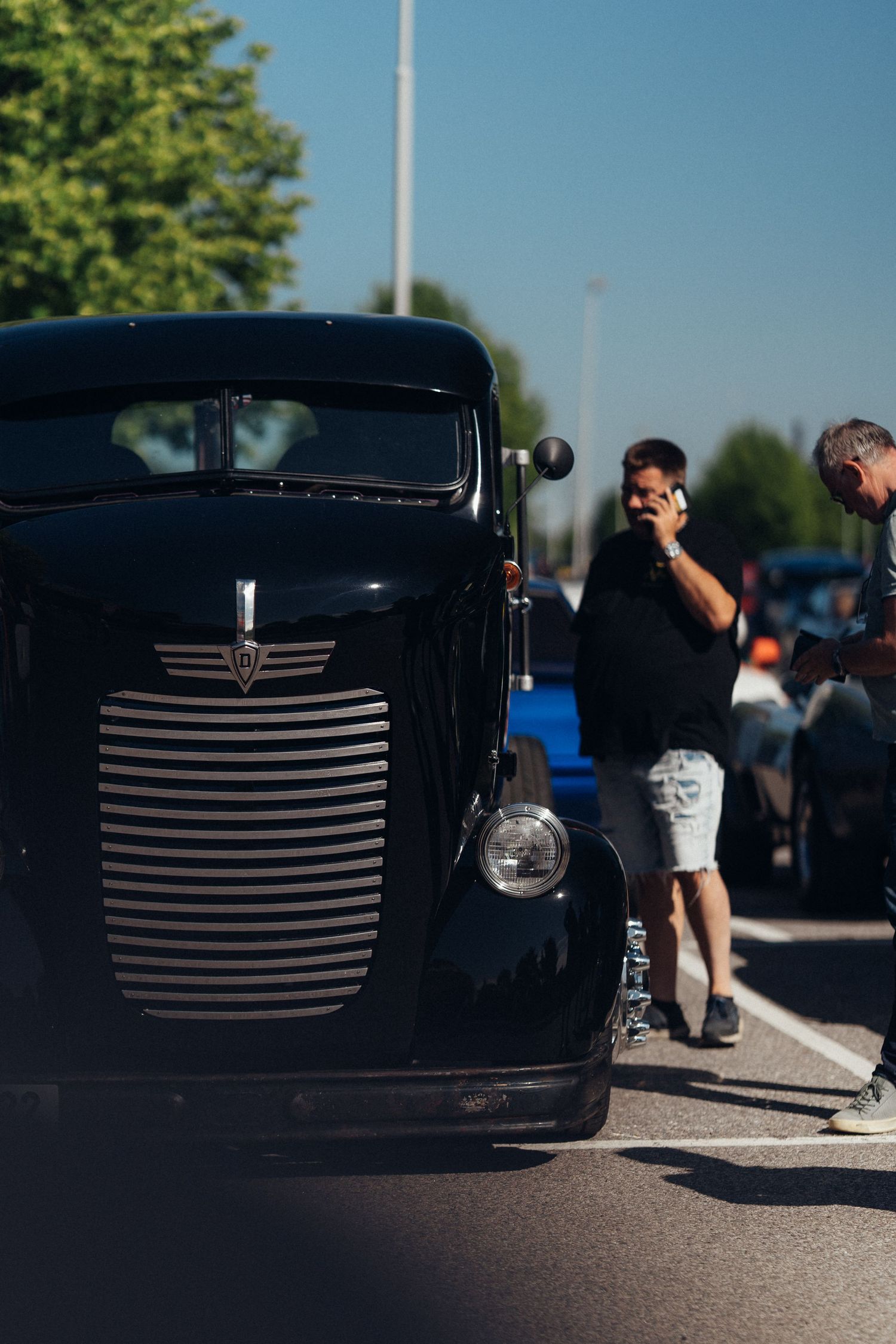 Black vintage hot rod with distinctive horizontal grille bars photographed from the front.