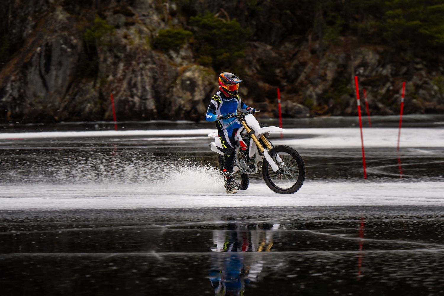 Mountain biker splashes through a water crossing during an intense off-road race competition.