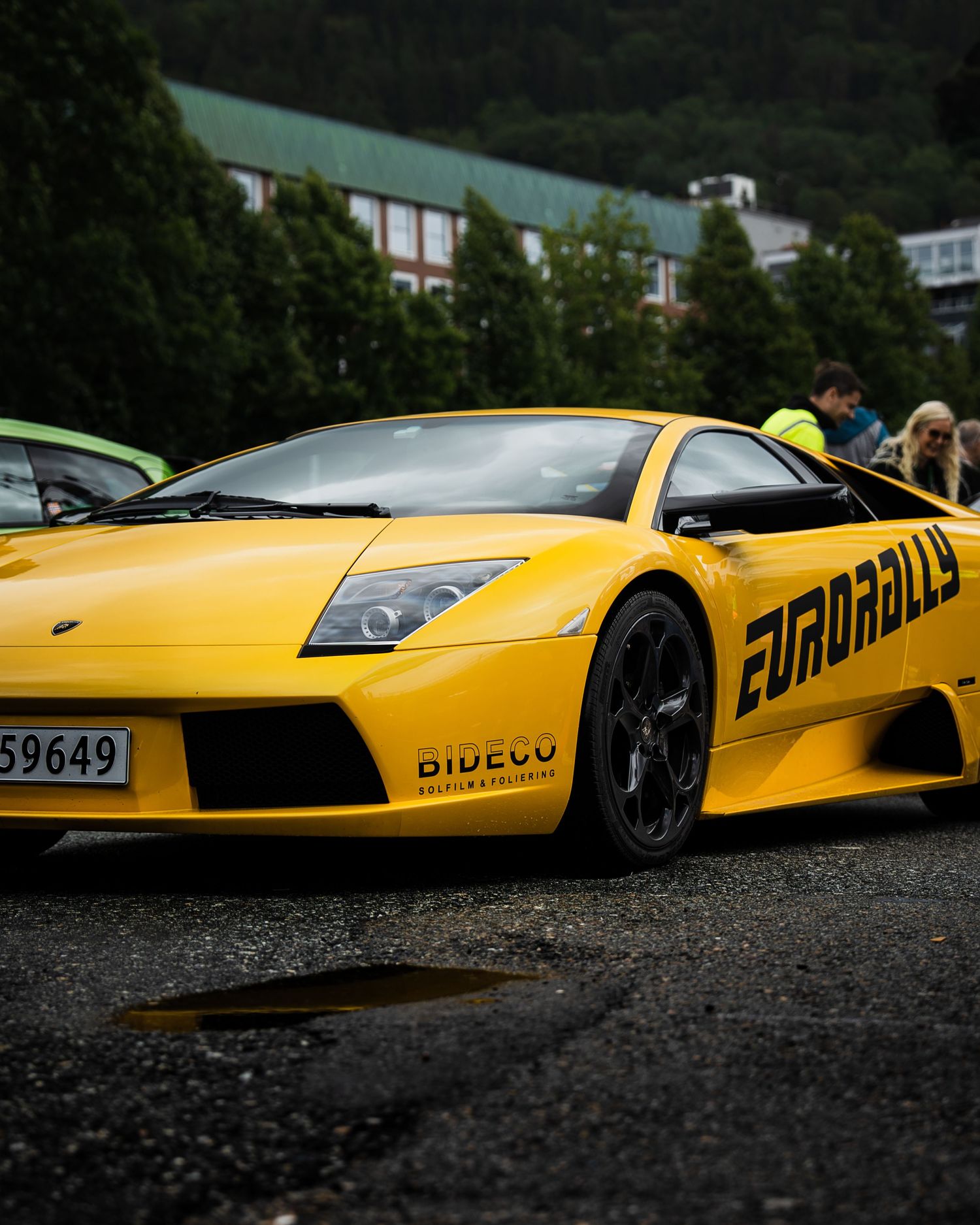 Yellow Lamborghini Murcielago with custom Eurobahn livery parked against mountain backdrop.