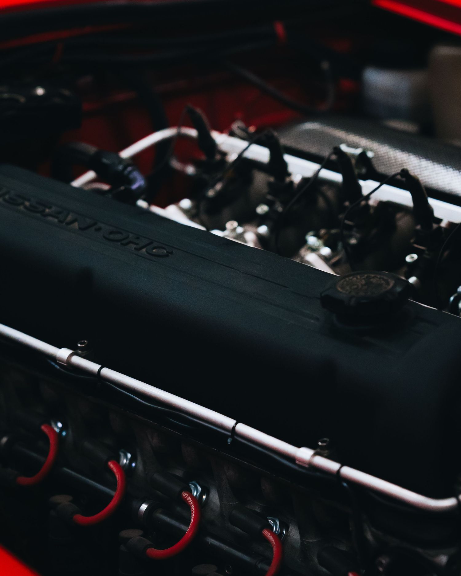 Engine bay detail showing performance components with red accents and wiring.