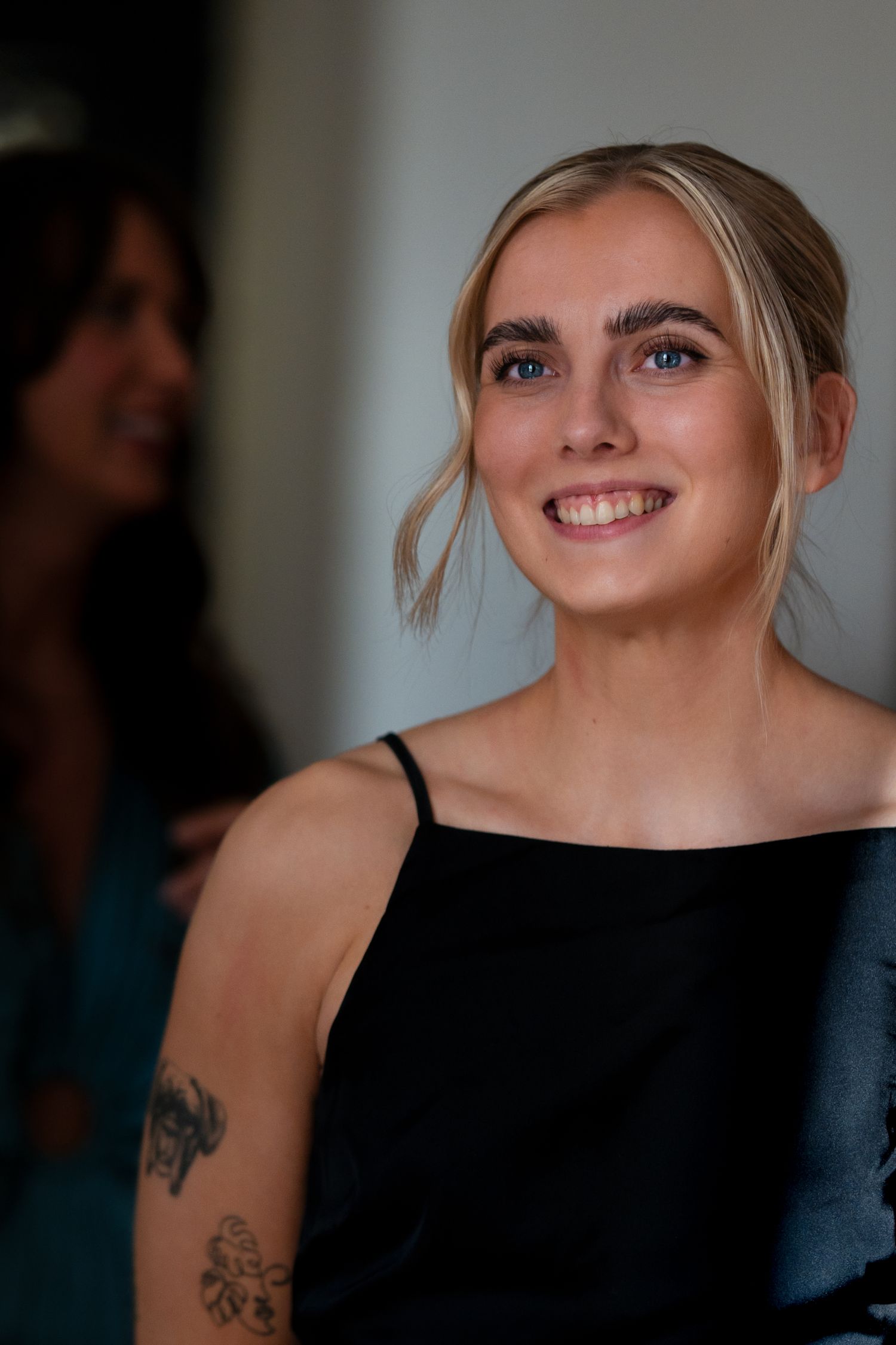 Close up portrait of person in black dress with soft lighting and natural expression.