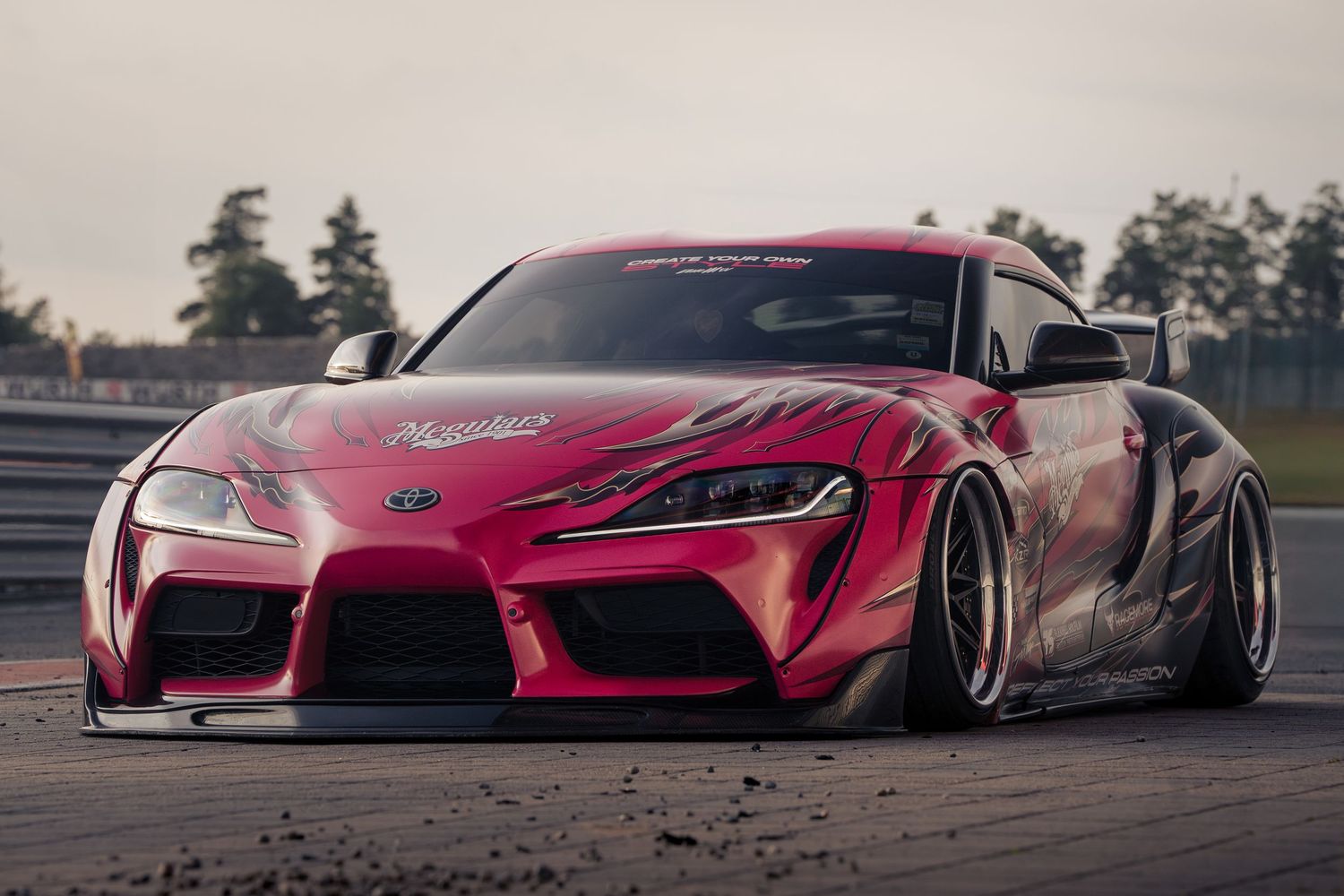 Red sports car concept designs showcasing sleek aerodynamic profiles and futuristic styling elements in digital renders.