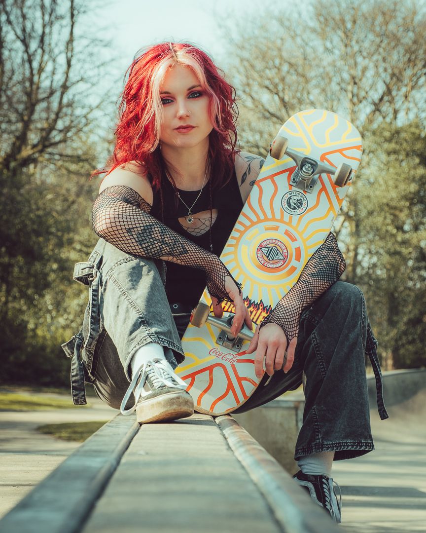 Artistic skateboarding photo series showing a person in denim and black holding a decorated longboard in an outdoor setting.