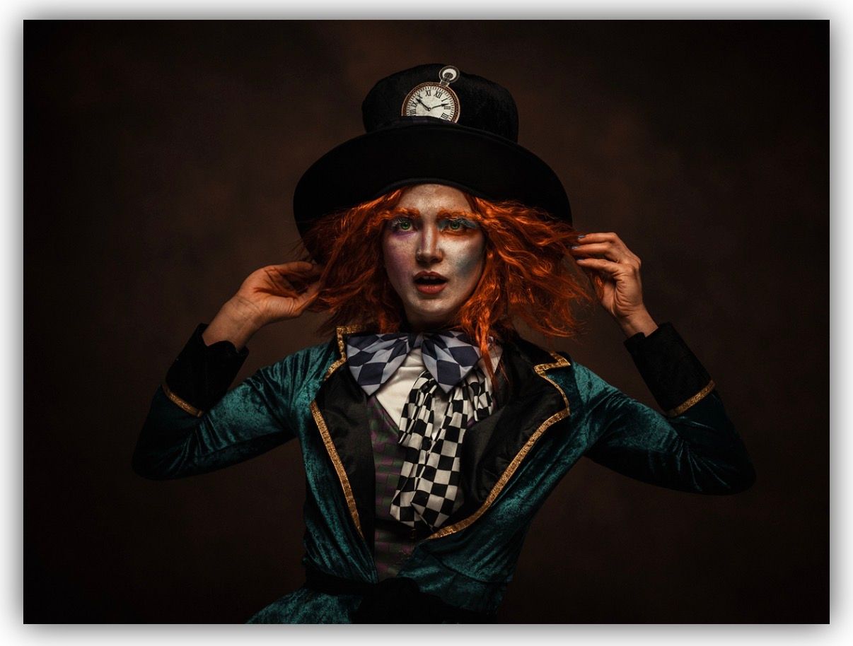 A dramatic portrait series showing someone in dark lighting wearing a teal jacket and wide brimmed hat against a black background.