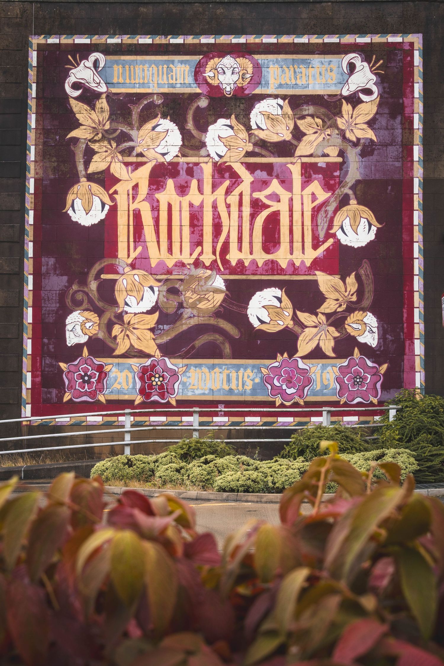 Decorative illuminated signage panels with ornate floral designs and text displayed in a row.