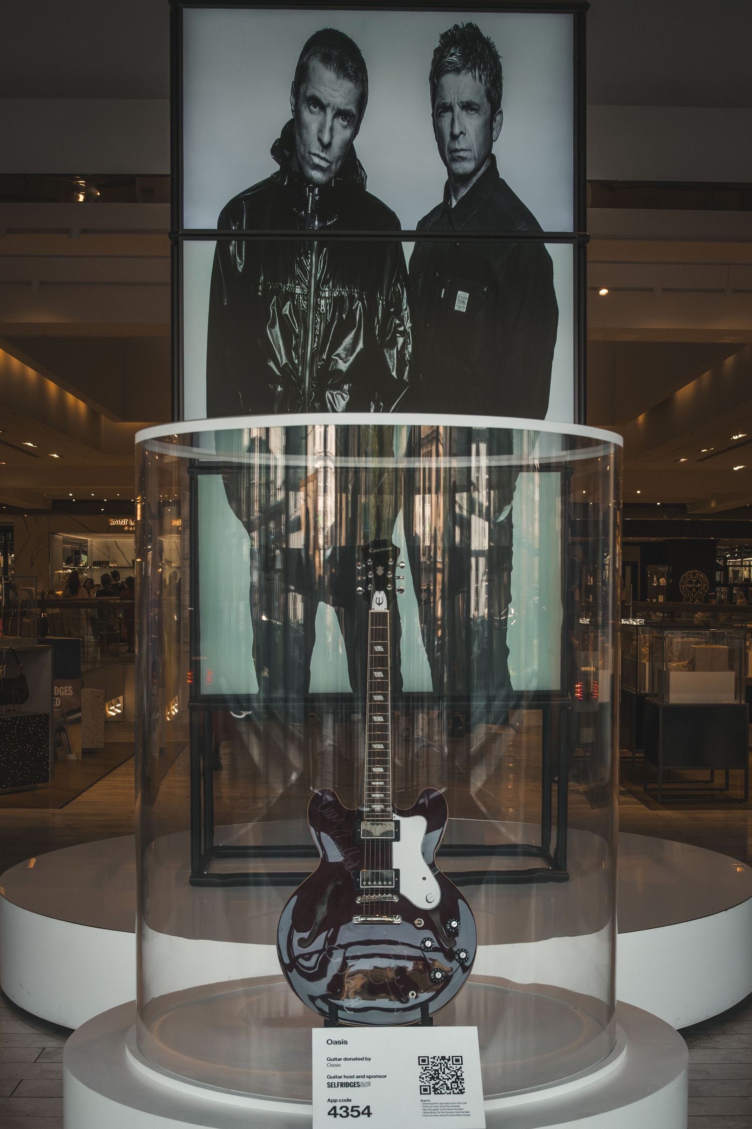 Museum display case featuring a black and white photography exhibit in a modern gallery setting.