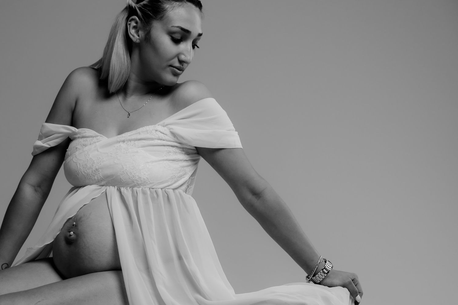 A graceful series of dance movements captured in soft lighting showing flowing white fabric.