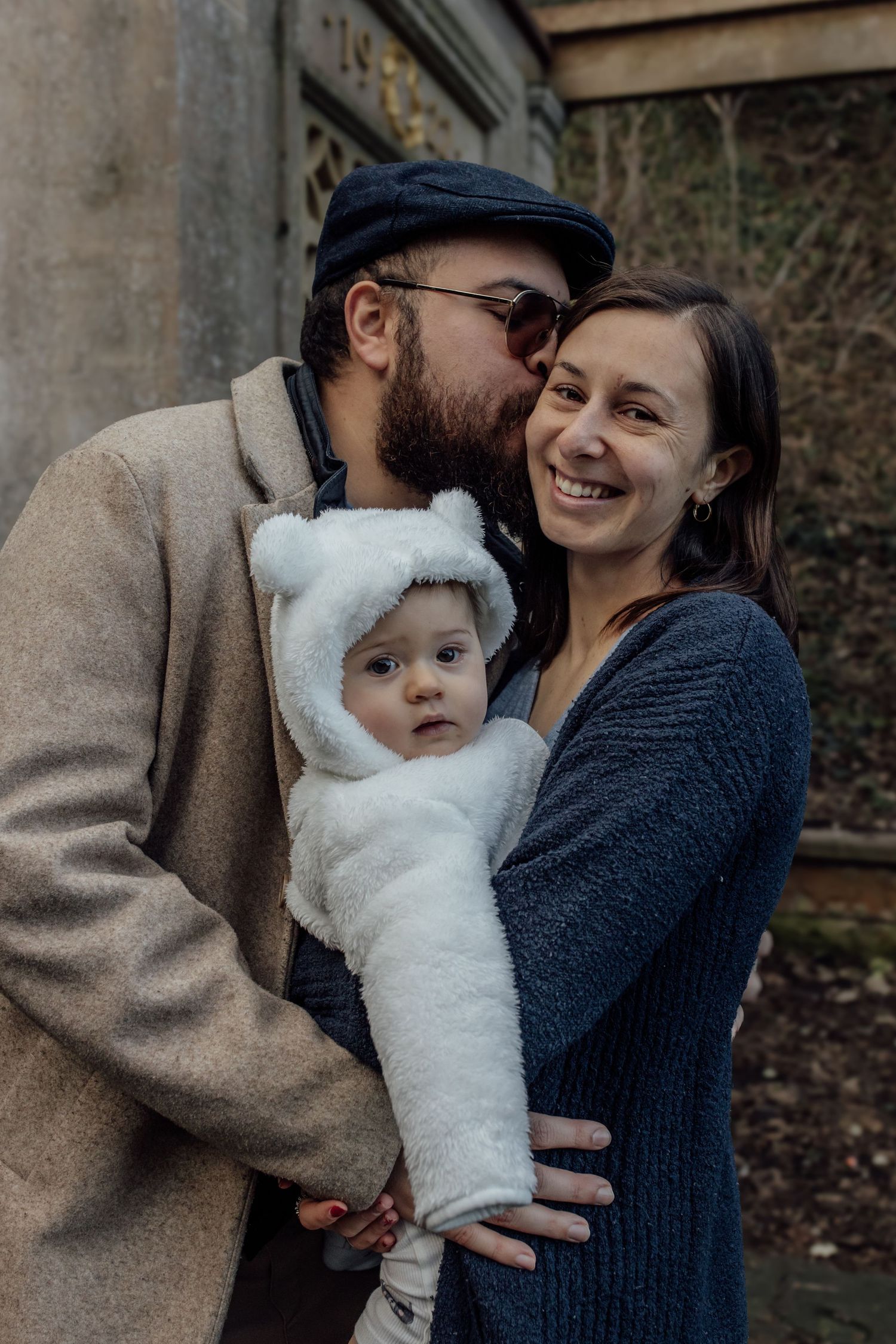 A series of five intimate outdoor family portraits showing tender moments between parents and their baby in winter clothing.