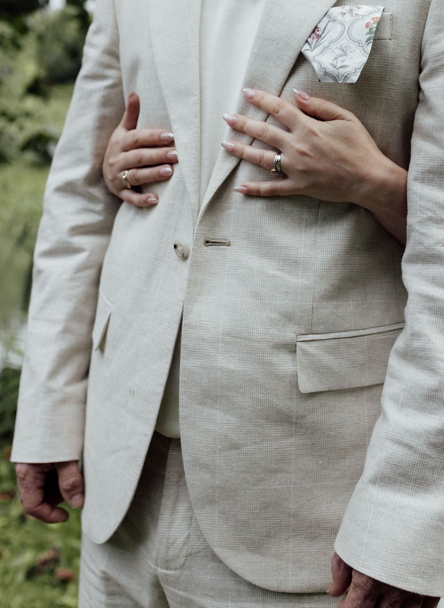 Close-up view of a light beige linen suit jacket showing details of buttons and pockets in multiple angles.