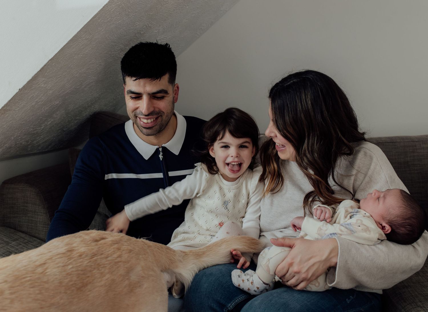 A collection of candid family moments shows people cuddling and interacting on a couch in warm indoor lighting.