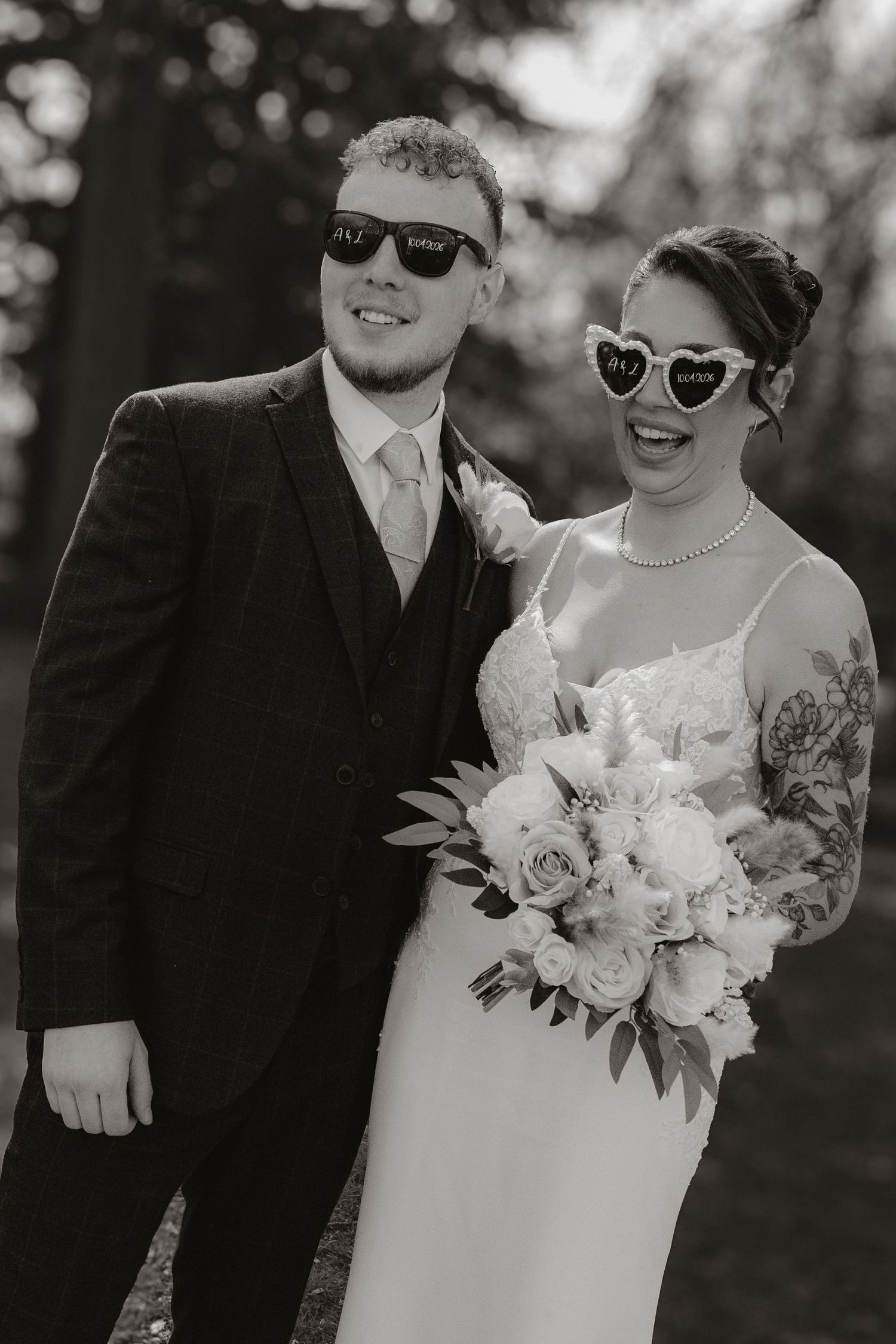 Bride and groom stand together laughing.