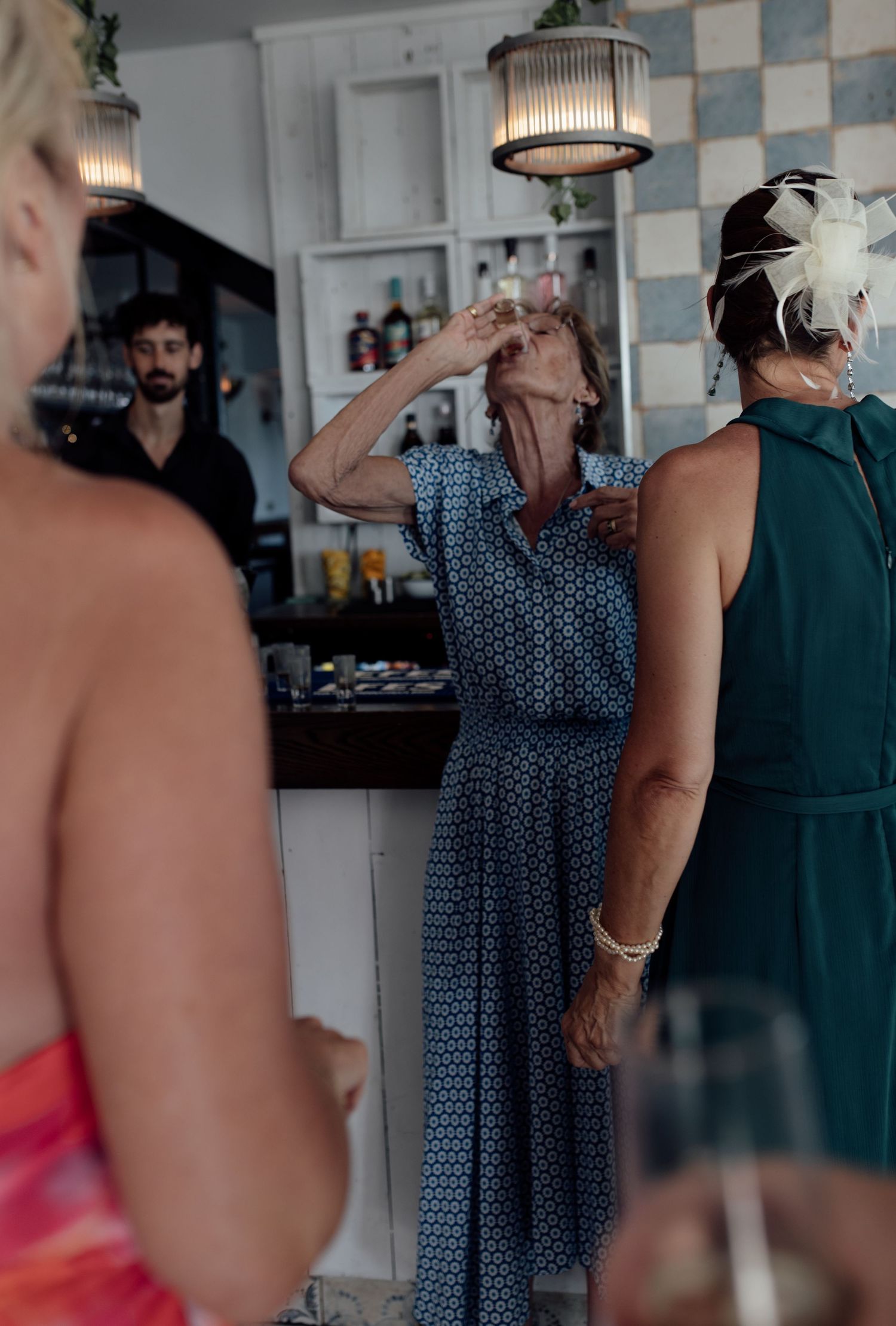 A sequence of blurred candid shots showing people interacting in a restaurant or bar setting with checkered walls.