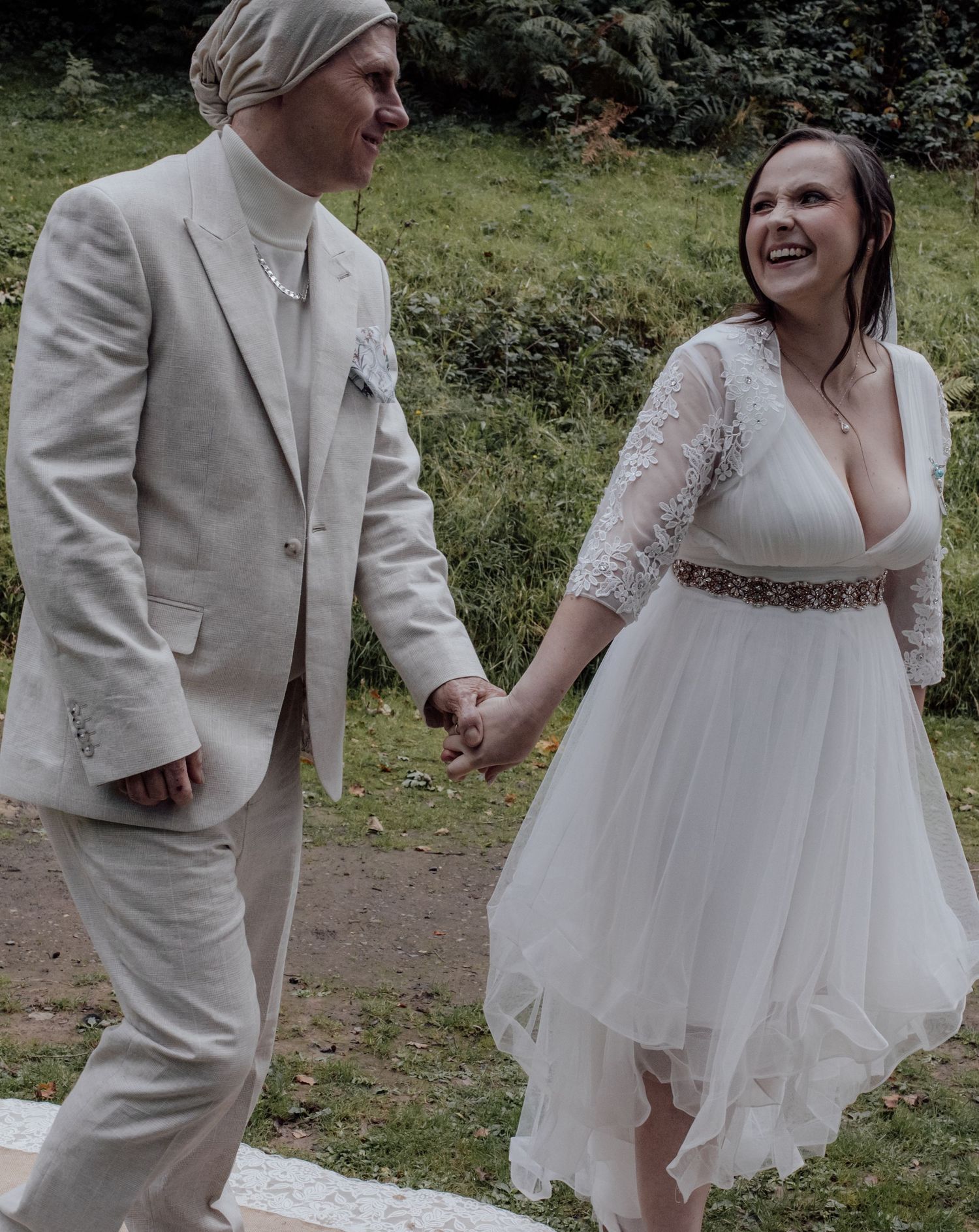 A couple in wedding attire dances and laughs together outdoors in a series of candid moments.