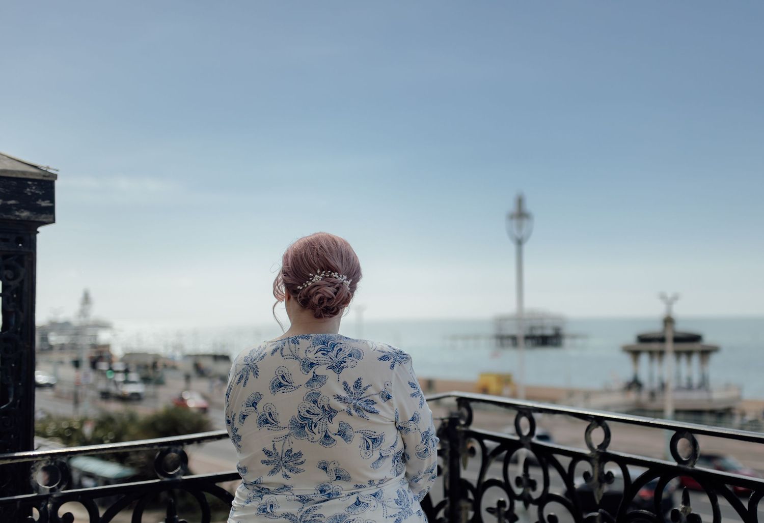 A person stands at a seaside balcony overlooking the ocean with multiple scenic views shown in a collage format.
