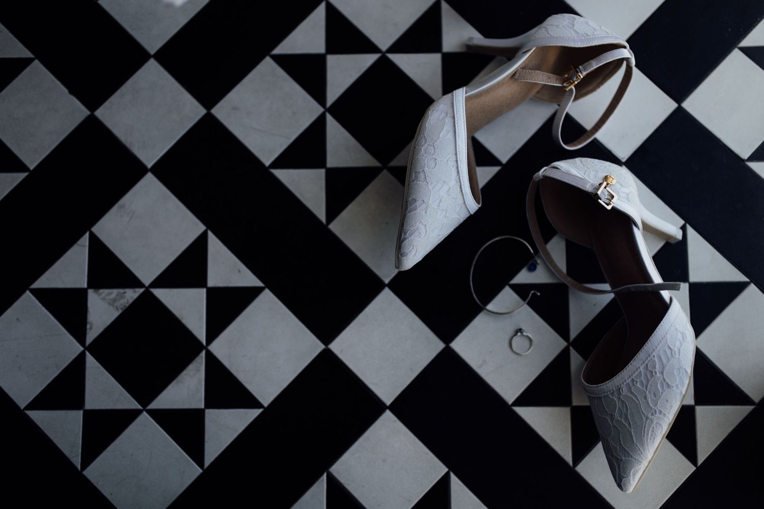 Black and white geometric pattern with triangles and squares forming a repeating architectural design.