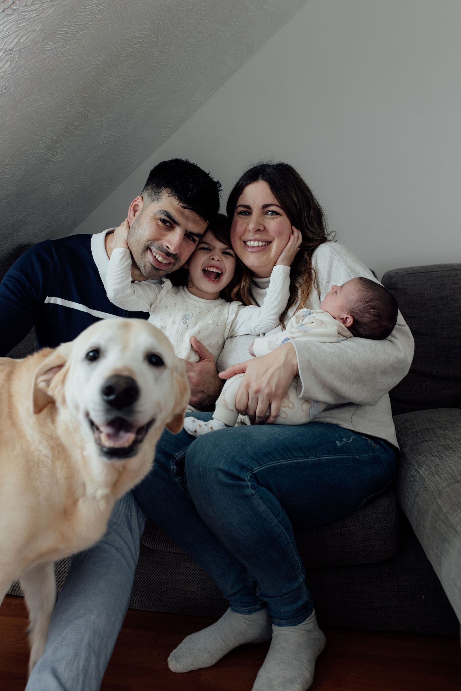 A happy white dog and people share joyful moments together on a couch in a series of candid photos.