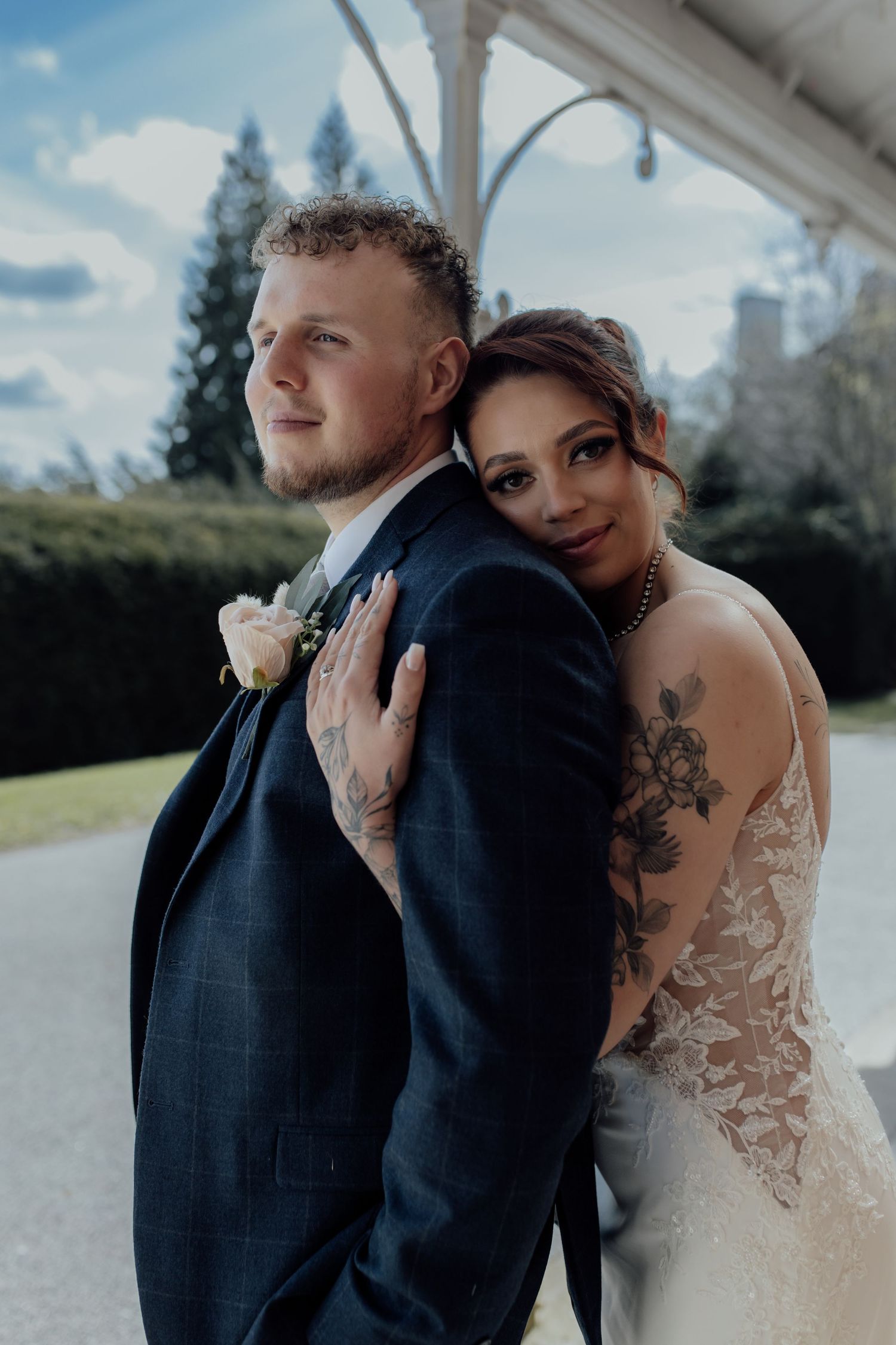 Bride hugs groom for a couples photos