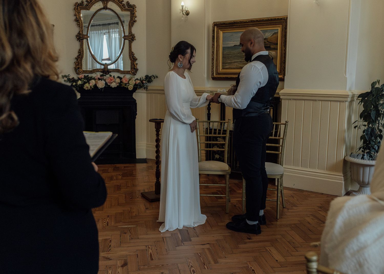 A wedding ceremony sequence shows a couple exchanging vows in a traditional indoor setting with white decor and floral arrangements.