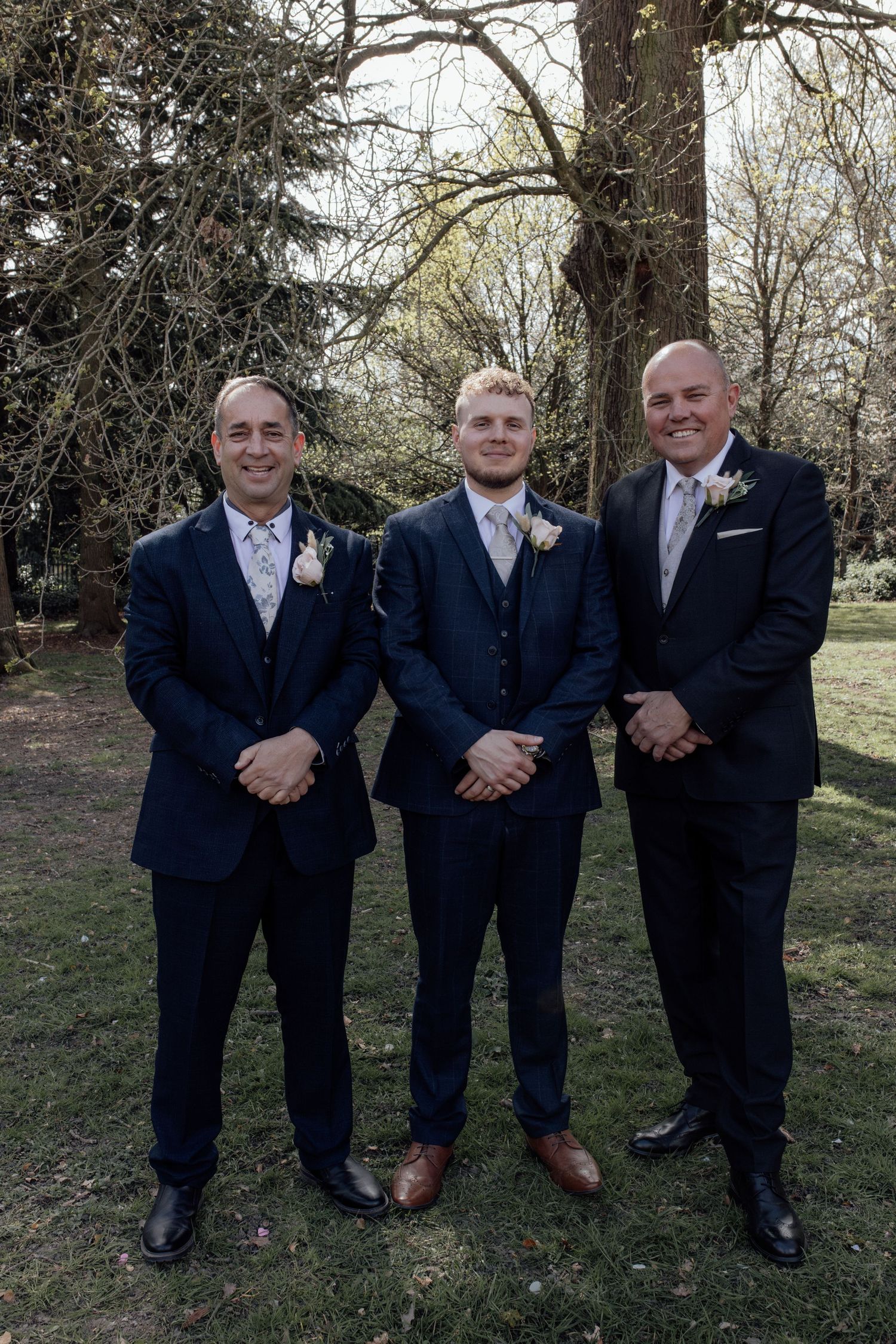 Groom and groomsmen stand together for a photo after  wedding ceremony