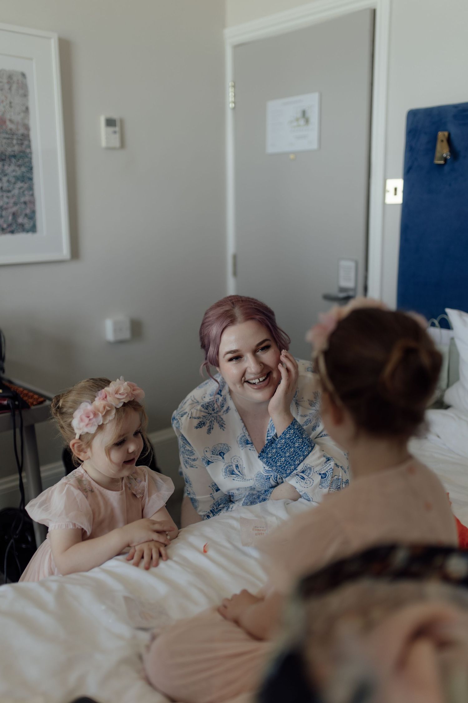 Four sequential photos show people laughing together while resting on a bed.