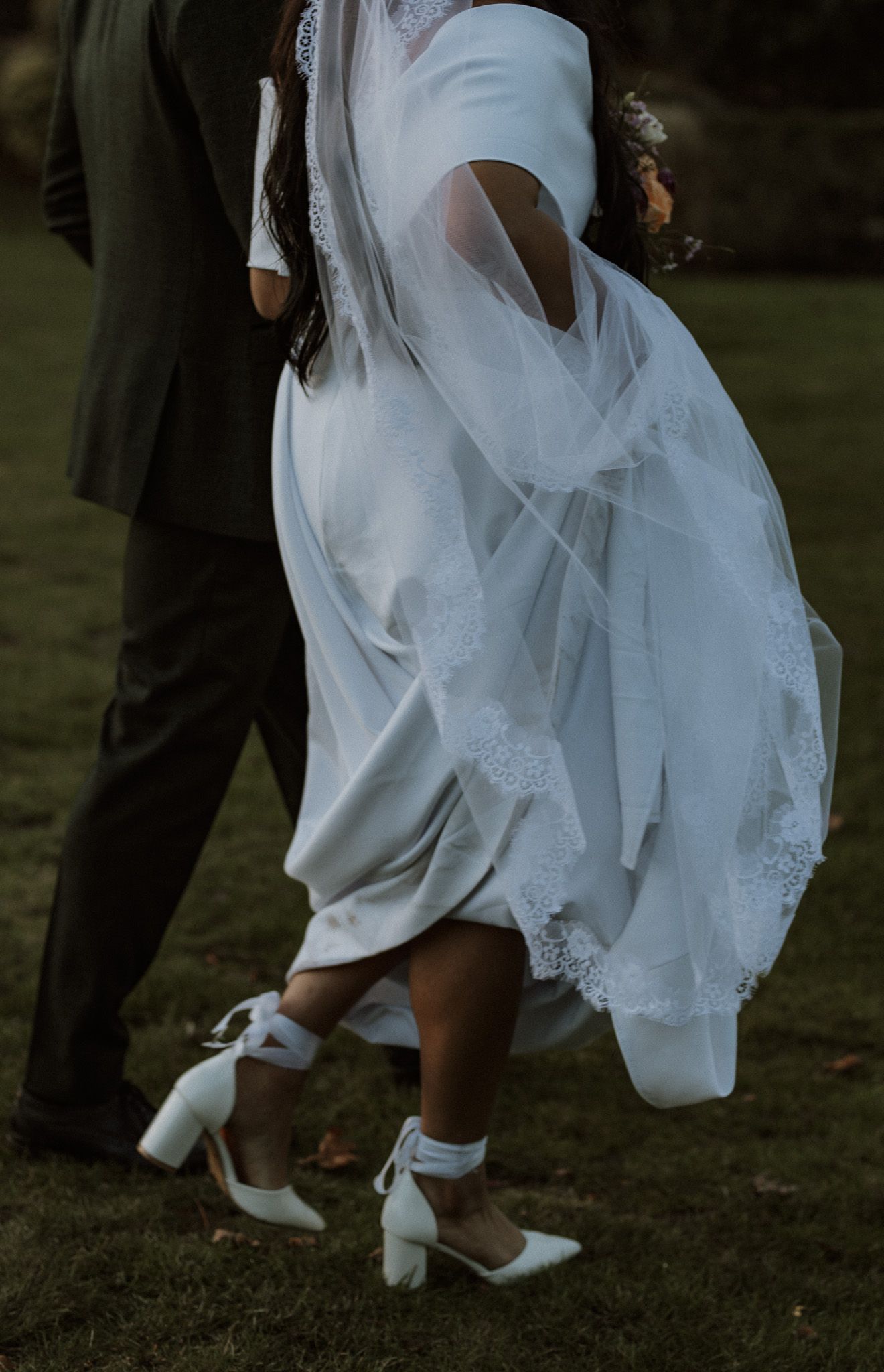 Bride and Groom walk hand and hand.