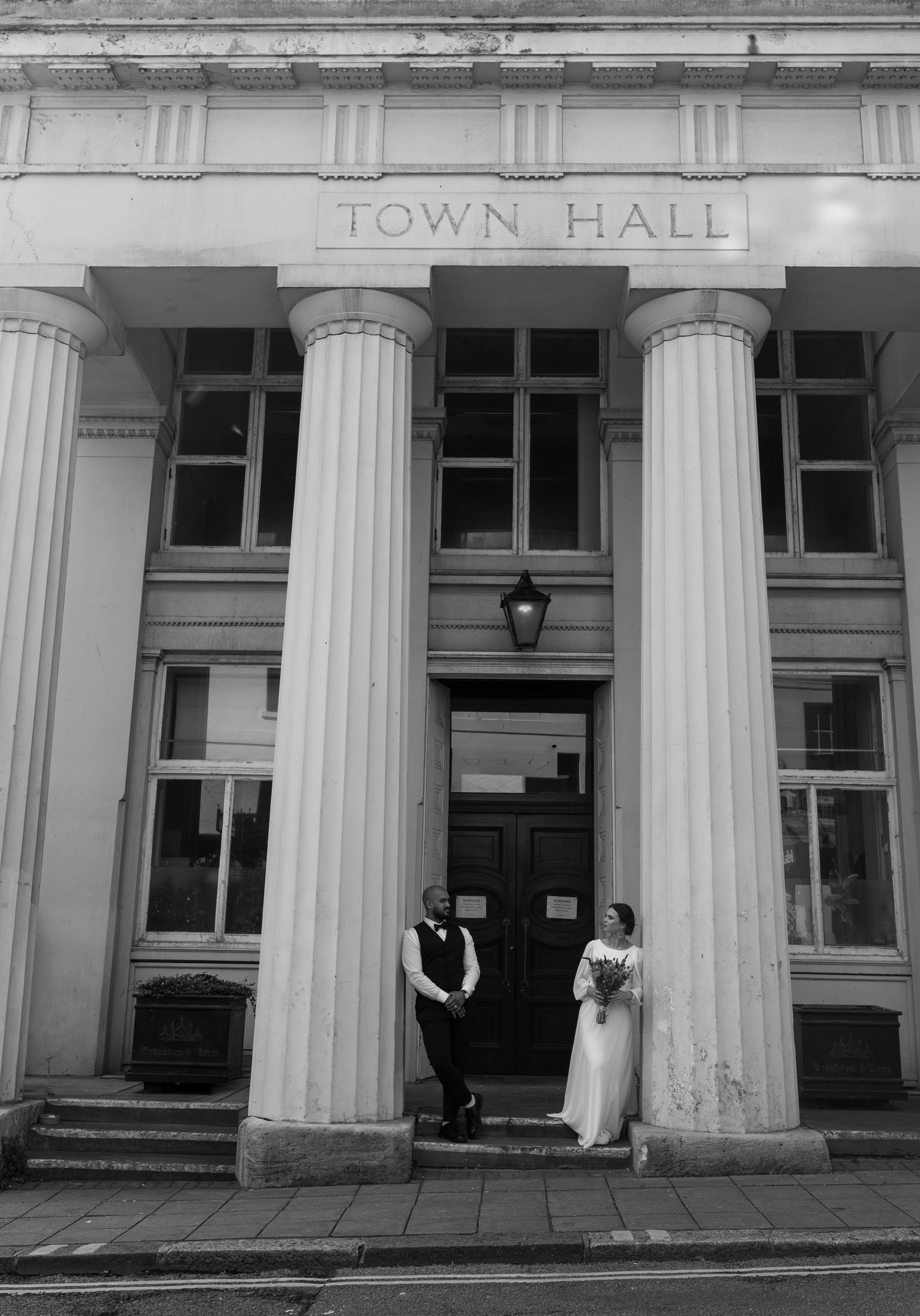 A black and white photo series showing the exterior columns and entrance of a historic town hall building.