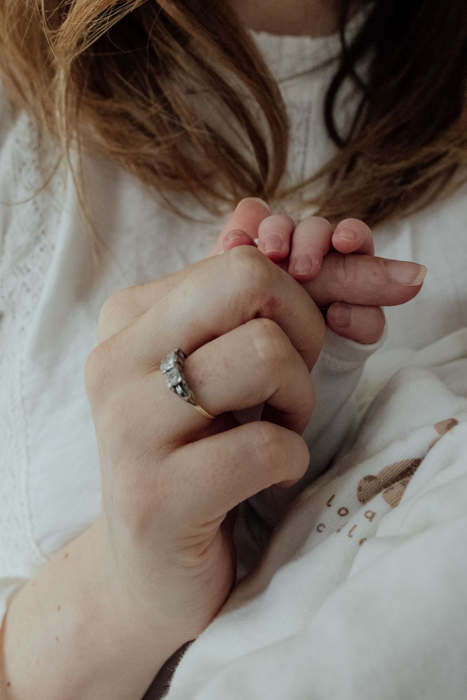 Close-up sequence of hands with a delicate ring showing different angles and poses against a white background.