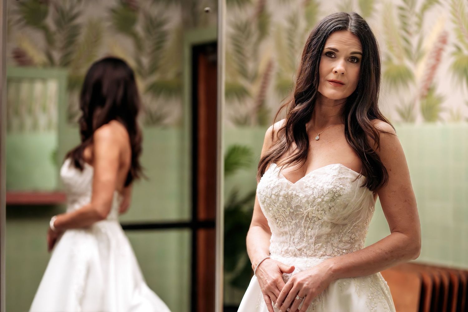 “Moody portrait of a bride in the Surf Ballroom bathroom, with the mirror reflecting her back.”