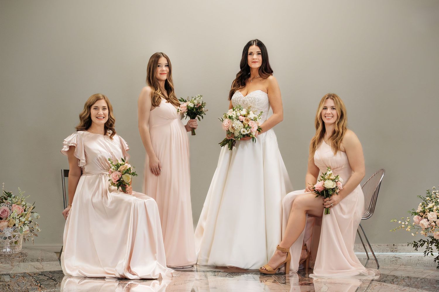 “Bride and bridal party in a formal posed portrait.”