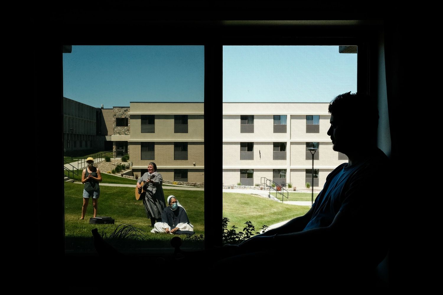 Dark silhouettes of figures against windows in a series of interior architectural shots.