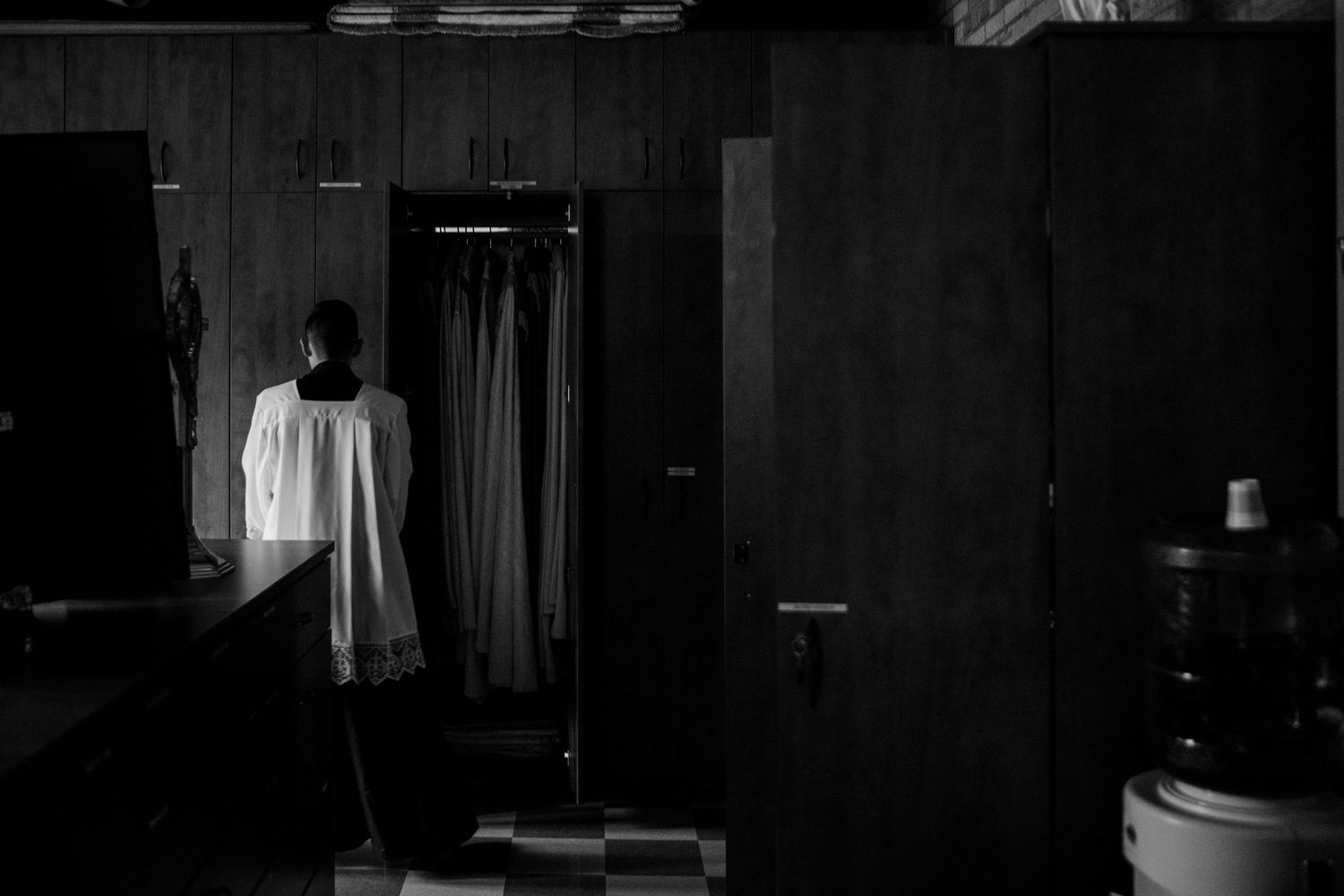 Dark and moody black and white film stills arranged in a horizontal sequence showing interior scenes.