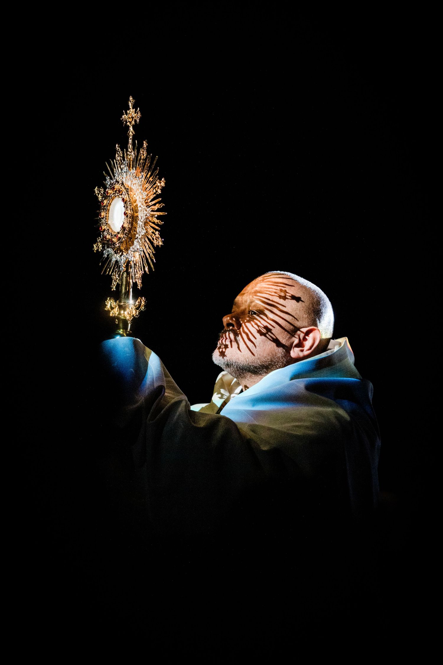 Dramatic side-lit scene with sparkler or light effect against dark background.