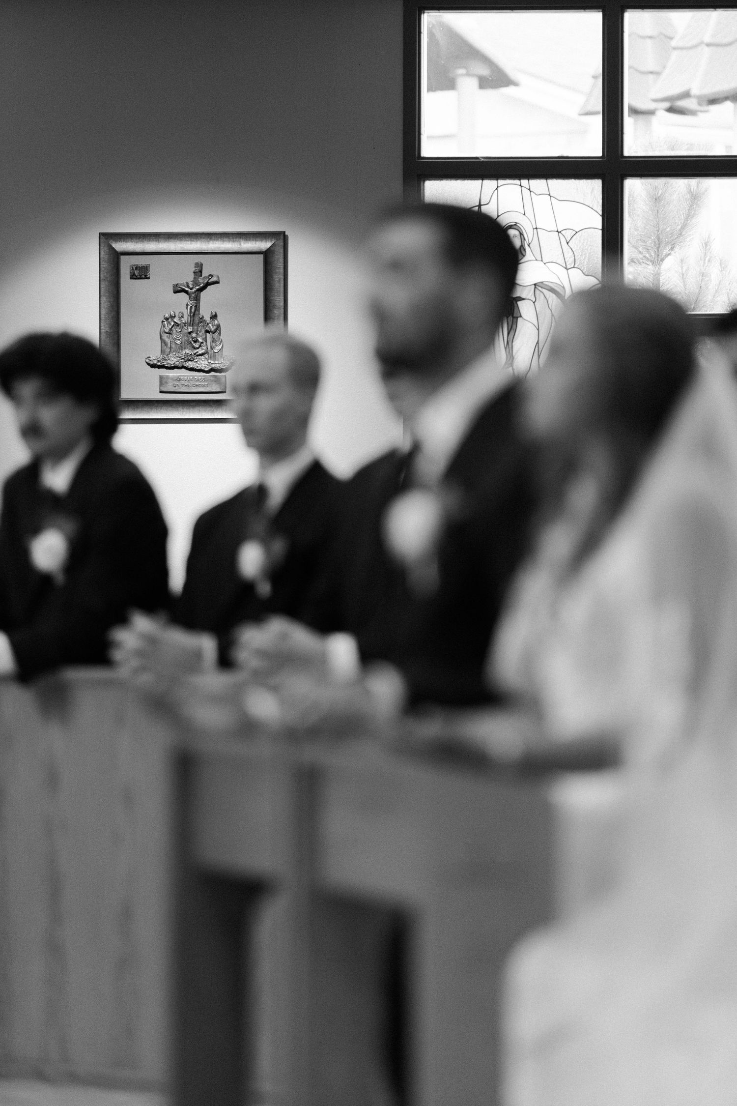 Black and white photo of a bride and groom at the altar during a church wedding ceremony.