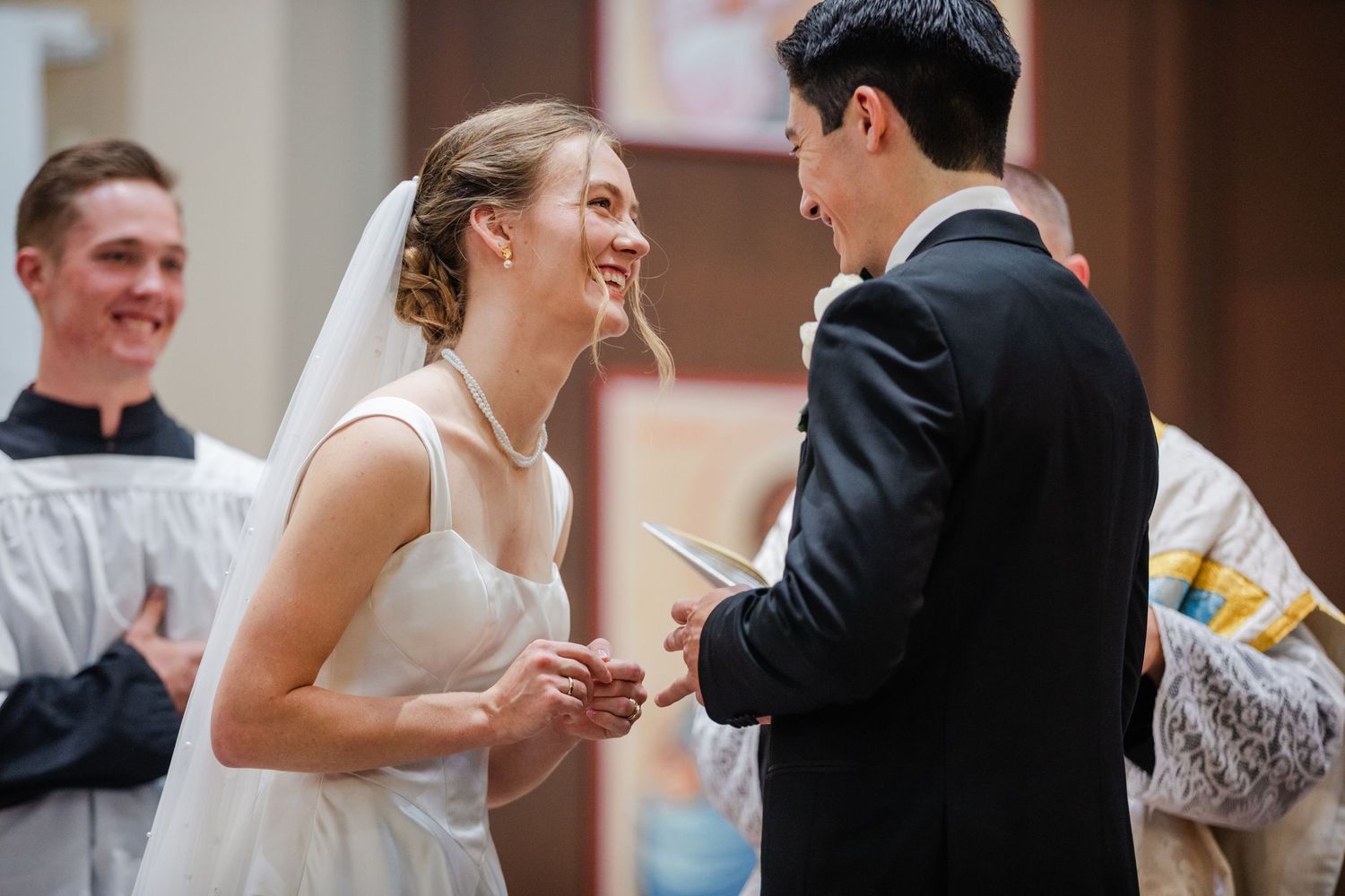 Couples dancing and celebrating at an elegant wedding reception in formal attire.