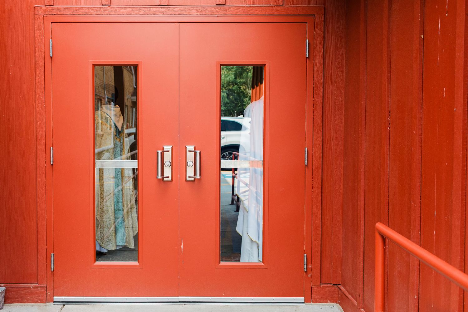A long corridor of vibrant orange torii gates at a Japanese shrine creates a striking architectural pattern.