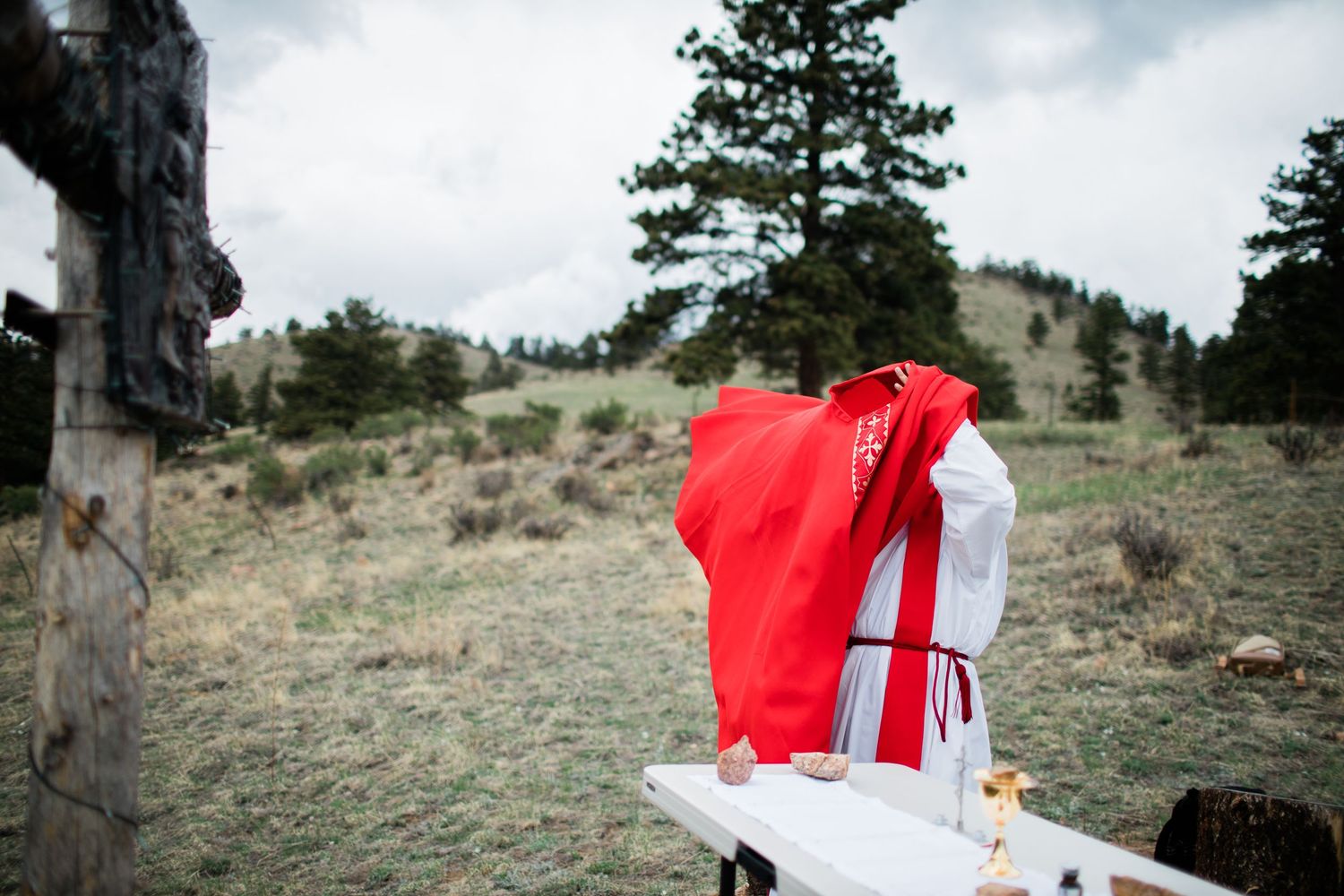 Red and white flowing garments against a mountainous landscape backdrop.