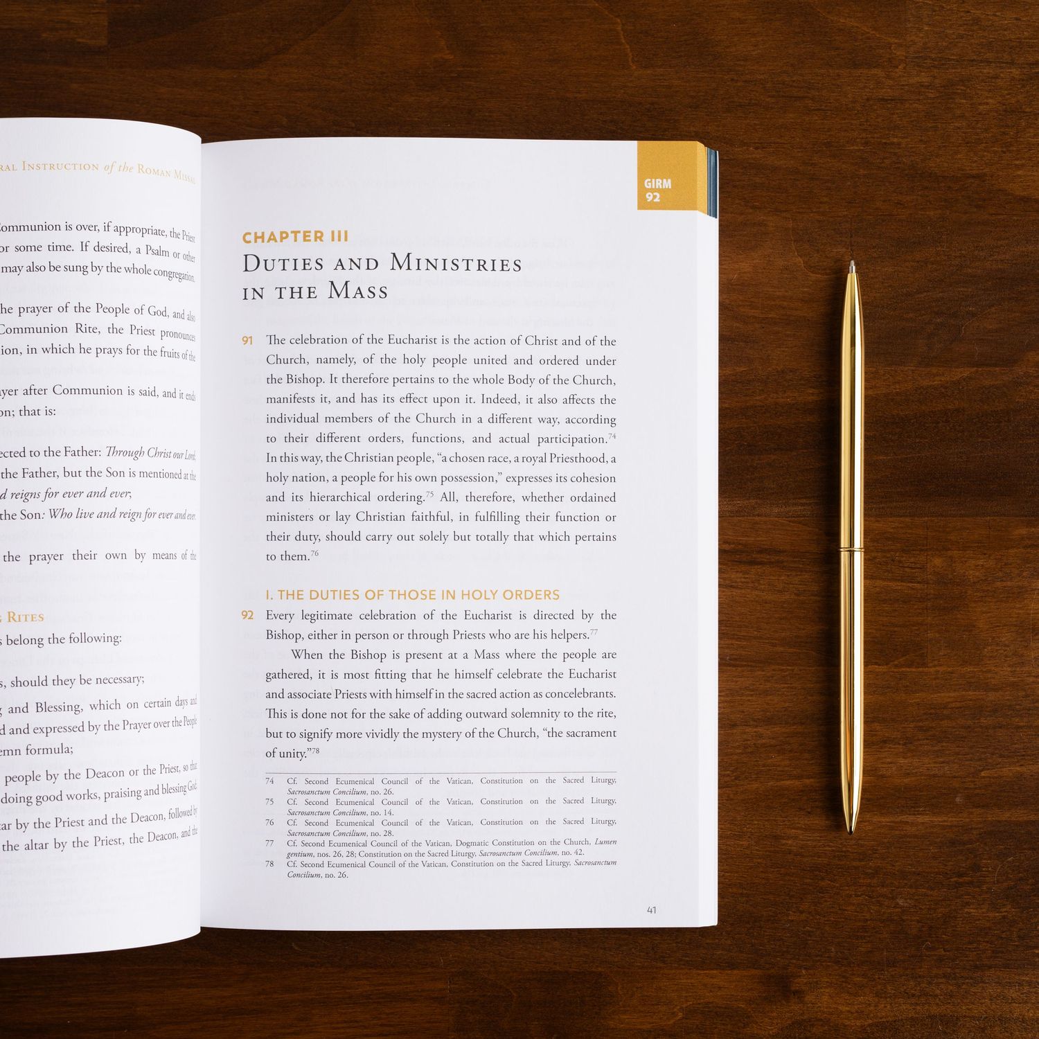 Open book with chapter heading and gold pen on dark wooden desk surface.