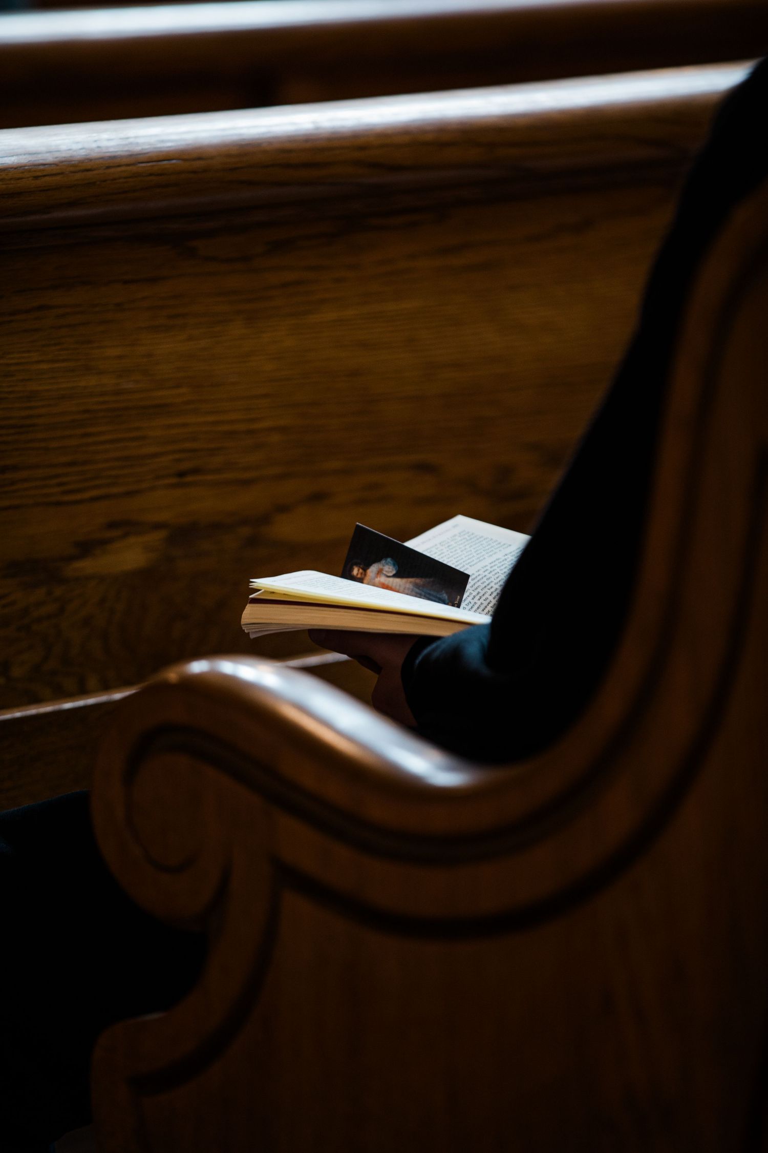 Close-up shots of dark wooden furniture details showing curved decorative elements in low light.