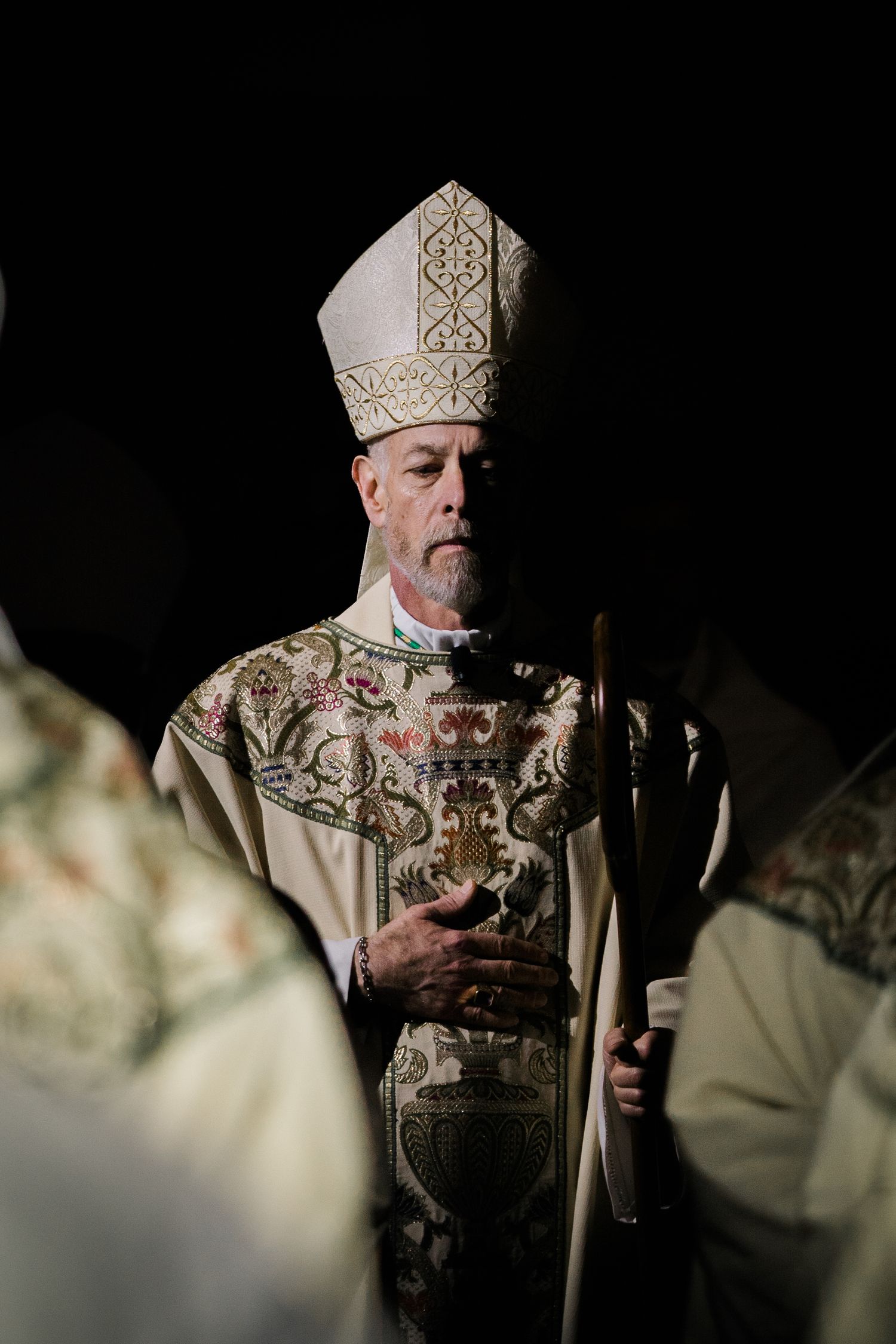 A series of dark atmospheric photos showing a person wearing ornate religious vestments and ceremonial headpiece.
