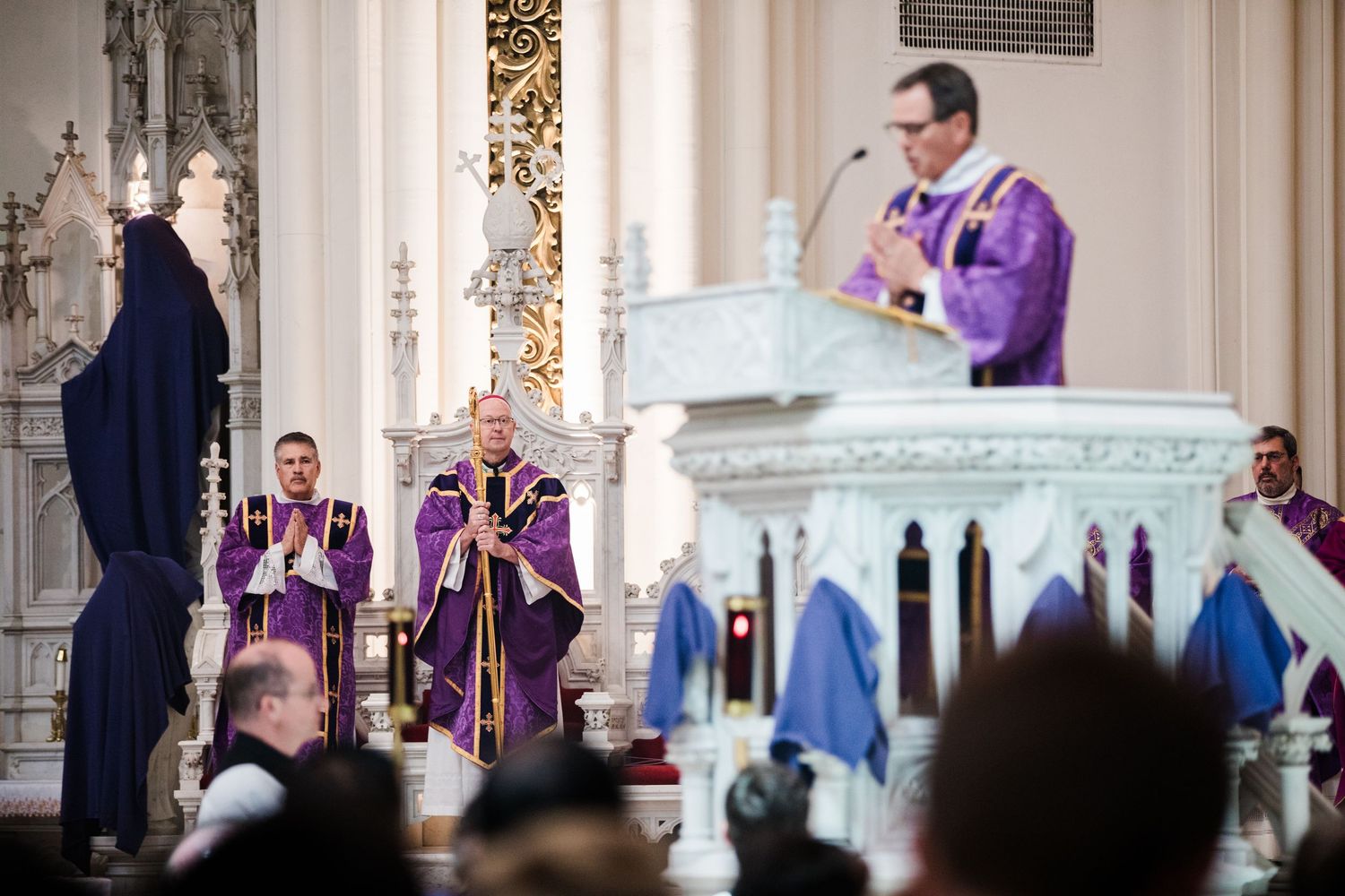 View of a church altar from the congregation's perspective during a religious ceremony.