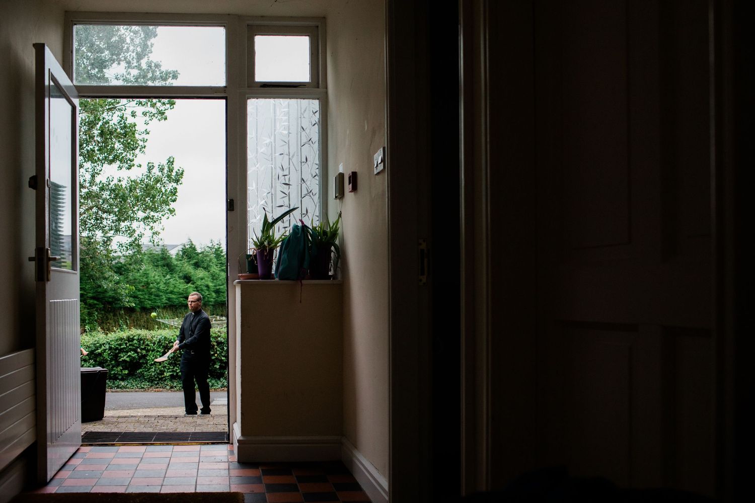 Empty hallway leads to bright window with natural light streaming in through panes.