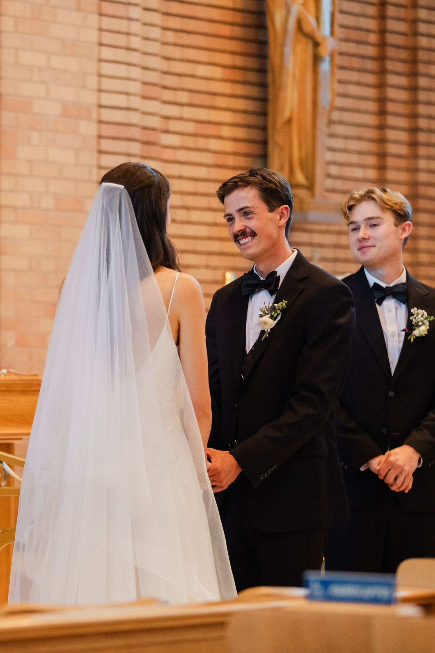 A joyful moment during a wedding ceremony in a church as the couple exchanges vows at the altar.