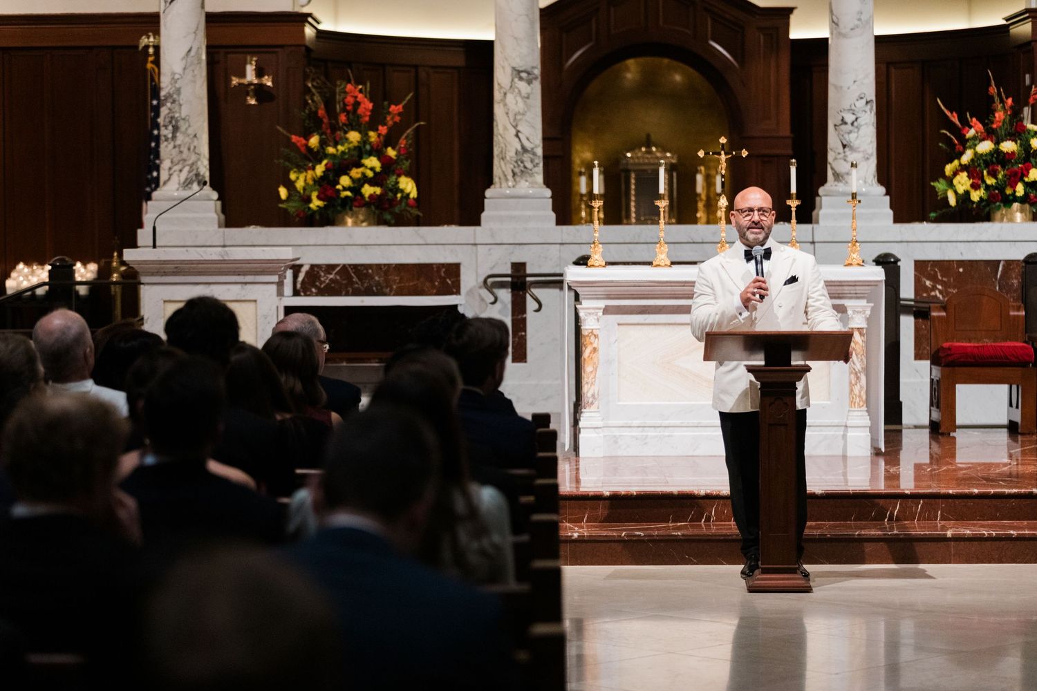 A traditional church wedding ceremony takes place in a grand cathedral with ornate decorations and floral arrangements.