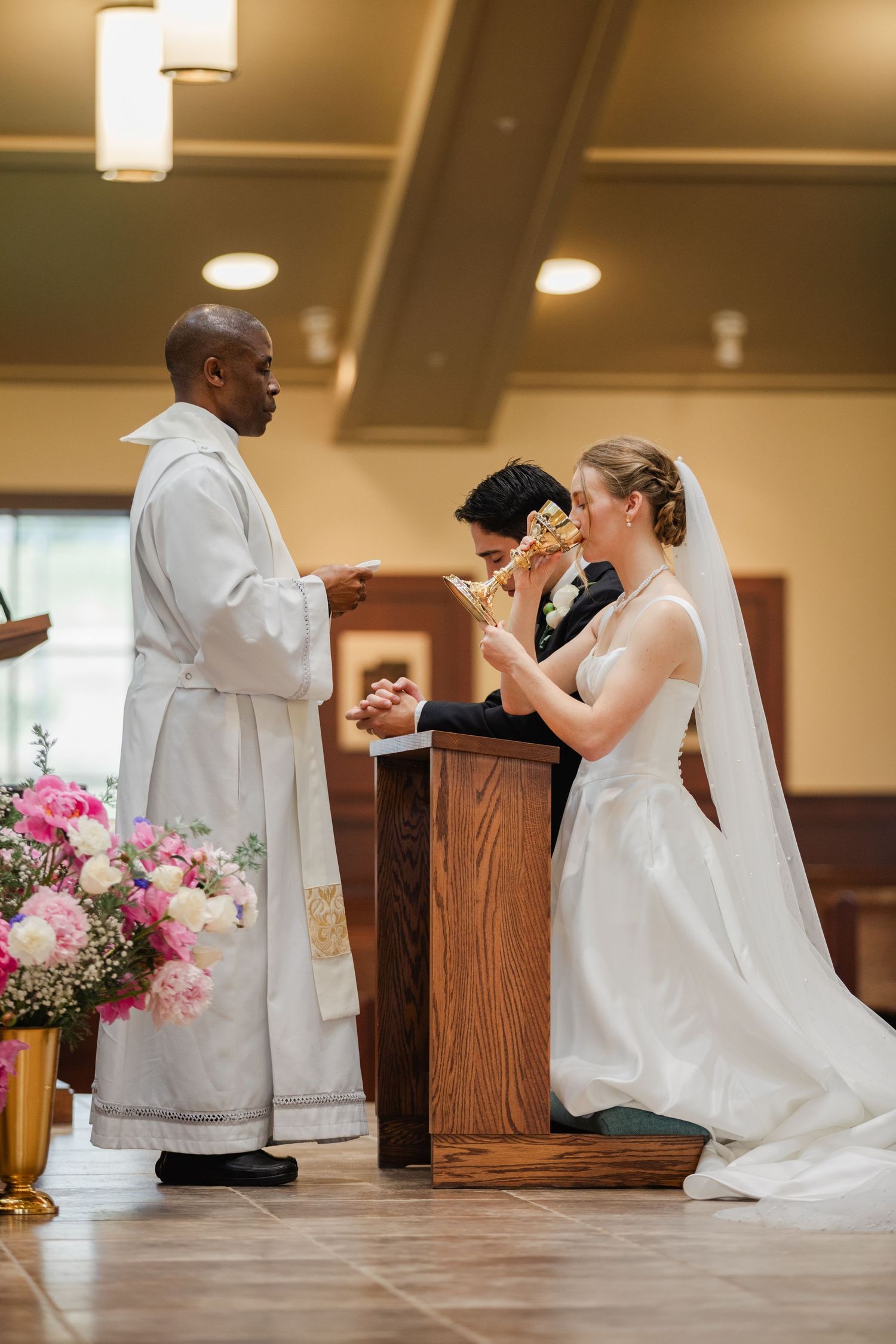 Sequence of wedding ceremony moments in a church with pink floral arrangements and white decor.